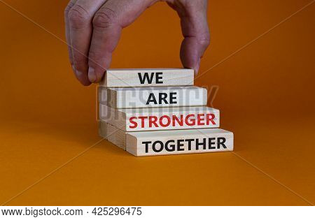 Stronger Together Symbol. Wooden Block With Words 'we Are Stronger Together'. Beautiful Orange Backg