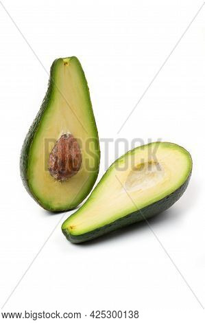 Two Halves Of Avocado Slices Isolated On A White Background
