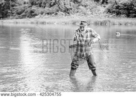 Fisherman Fishing Equipment. Hobby Sport Activity. Fisherman Alone Stand In River Water. Man Senior 