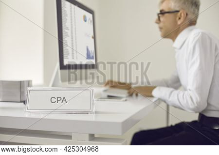 Middle-aged Man Cpa Manager Sits At A Computer Looking At Traffic Statistics.