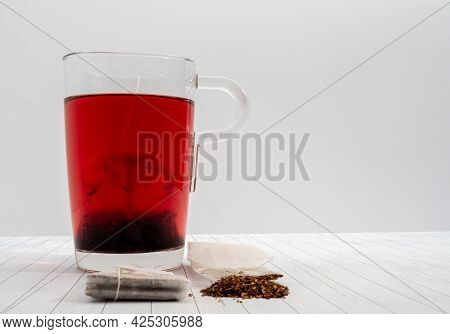 Fruit Tea In A Paper Bag And A Cup Of Tea. Side View.