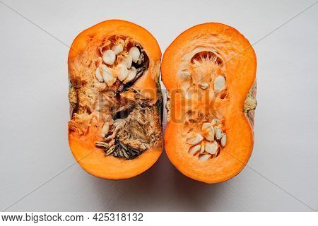 A Pumpkin Cut In Half, Left Half Is Rotten, Right Half - Good Quality, On A White Background.