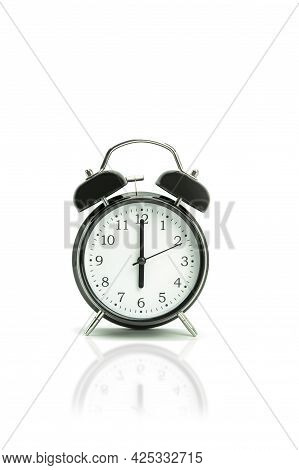 Retro Alarm Clock On A White Background. Black Alarm Clock Showing 6 Hours 00 Minutes On A White Bac