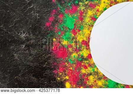 Color Splash Of Holi Powder, Dry Paints Gulal Around Circle Border Isolated On Dark Concrete Backgro