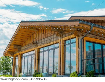Beautiful Wooden House With Large Stained Glass Windows On The Background Of The Summer Sky