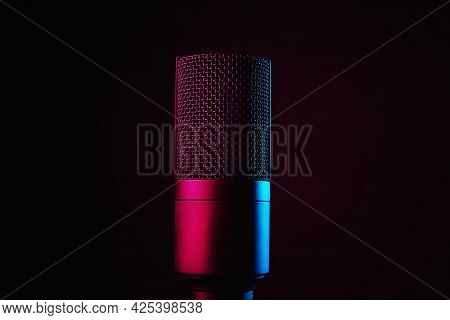 Studio Microphone On Dark Background With Copy Space. Black Professional Condencer Microphone With N