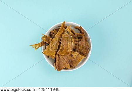 Fragrant Training Treats For Pets On Blue Background. Natural Air Dried Dog Treats In A White Cerami