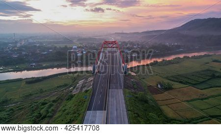 Aerial View Of The Kalikuto Bridge, An Iconic Red Bridge At Trans Java Toll Road, Batang When Sunris