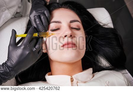 Close-up Snapshot Of Plasmolifting Procedure Injection. Plasma Injection Into Skin Under Eyes Of Pat