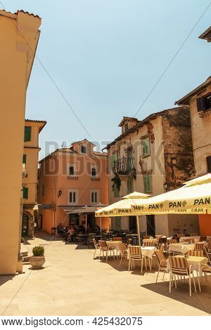 Lovran Croatia - 05 June 2021: Main Square Of Lovran Town With Restaurants And Houses In Traditional