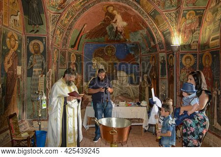 People During A Baptism On The Church Of Panagia Phorviotissa At Nikitari On Cyprus Island