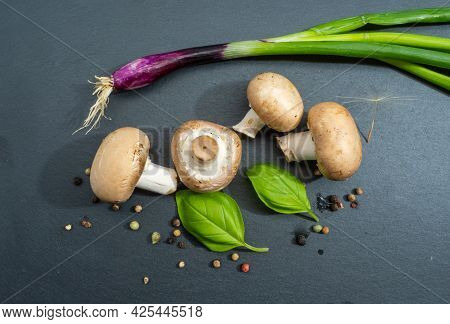 Champignon Mushrooms On A Black Background Close Up.