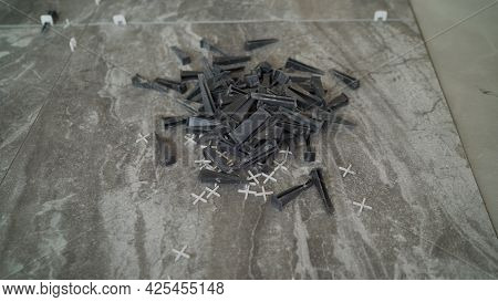 Plastic Cross For Leveling Tiles During Construction Or Renovation. Floor Tile Repair. Installation 