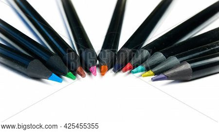 Colored Pencils Lying In A Semicircle On A White Background.