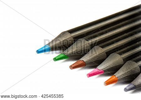 Colored Pencils Lying Diagonally On White Background.