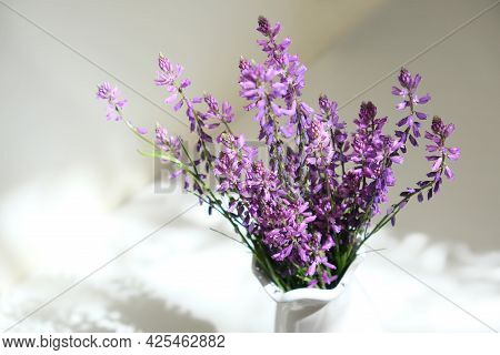 Bouquet Of Purple Wild Flowers Field Bell Flowers In White Vase On White Shelf In The Bathroom. The 