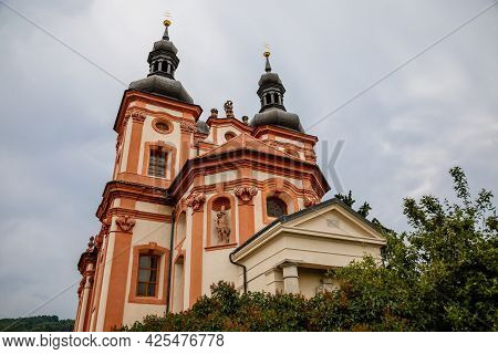 Valec, Western Bohemia, Czech Republic, 19 June 2021:  Baroque Red And Yellow Church Of The Holy Tri