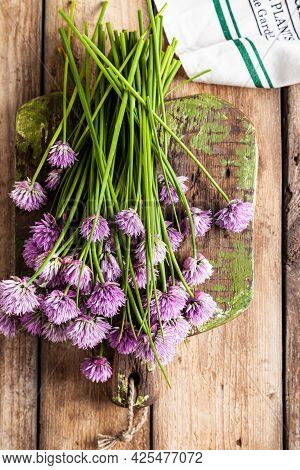 Schnitt-onion, Chives Flowers On A Wooden Board On A Wooden Background.
