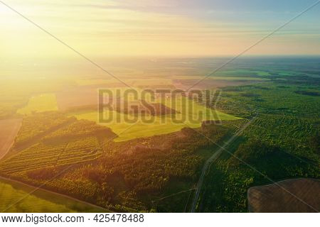 Aerial View Of Agricultural And Green Fields In Countruside In Sunset. Nature Landscape In Summer Da