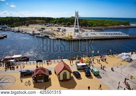 Ustka, Poland - July 01, 2014: Quay, harbor and movable footbridge over river Slupia in Ustka - popular resort at Baltic Sea. Panoramic view.