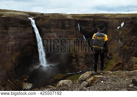 Photographer at the Haifoss waterfall, Iceland
