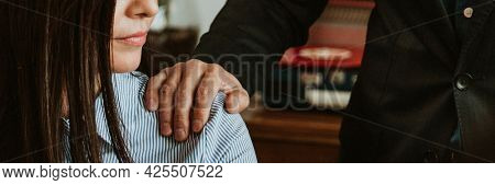 Businessman patting a colleague on her shoulder