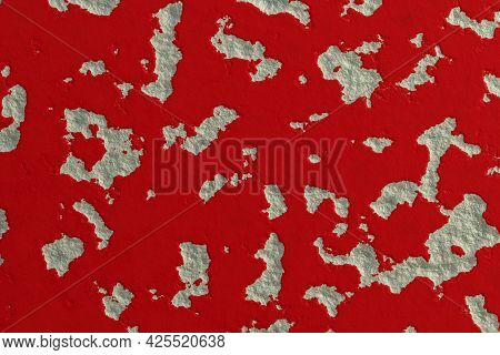 Wall In Red And White Colors With Spots Of Peeling Plaster. Grunge Background