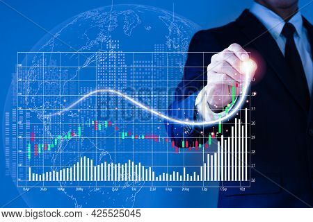 A Man Wearing A Suit  His Right Hand Poked A Pencil On A Fast-growing Stock Chart. Globe Background 