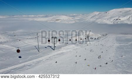 Ropeway On The Slope Of Erciyes Mount. Snow Covered Top Of Erciyes Stratovolcano. Aerial View Of Erc