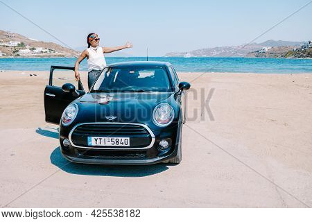 Mykonos Greece April 2018, Woman On A Road Trip, Mini Car On The Beach During Road Trip Mykonos Gree
