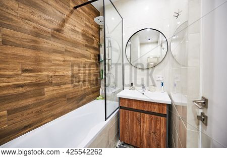 Stylish And Comfortable Version Of Bathroom Design In Small Space. White Color Of Rectangular Bathtu