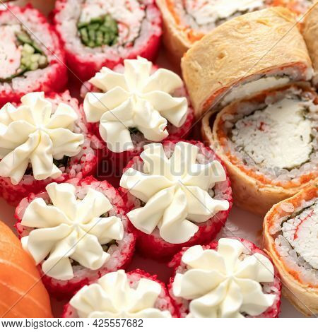 Cushi Roll Decorated With Cream Cheese. Close Up Shot. Soft Focus. Top View.