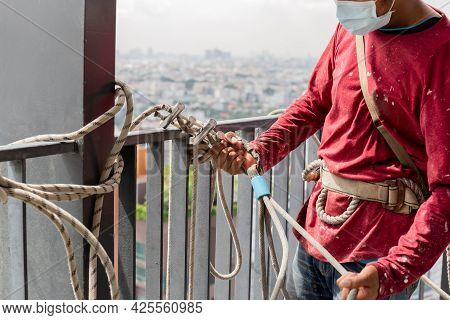 Construction Workers Holding Steel Hooks Connecting With Rope For Self Absorber Safety Device Equipm