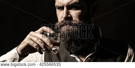 Attractive Man With A Whiskey. Man With Stylish Hair Mustache And Beard Drinking Brandy Or Whiskey F