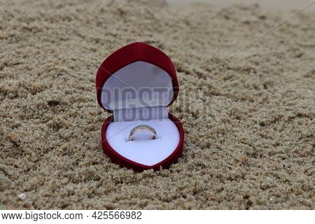 A Ring In A Box On A Sandy Beach. A Romantic Way To Propose. An Engagement Ring. Engagement Ring