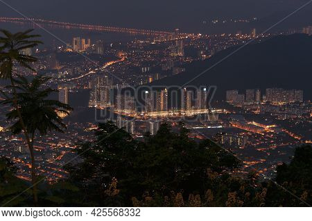 The Silhouette Of Palm Trees With A Night View Of The City Of Air Itam On The Island Of Penang Malay