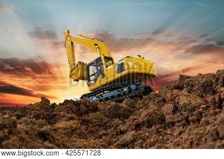 Excavators Are Digging The Soil In The Construction Site On The Sky And Cloud Background.