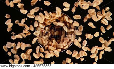 Rotating Peanuts on Black Background. Top Shot.