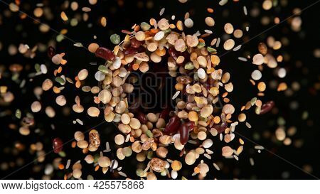 Rotating Raw Various Legumes on Black Background. Top Shot.