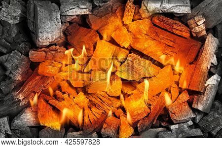 Close Up Red Hot Aglow Coals In Charcoal Grill With Fire Flames And Sparks, High Angle View, Directl