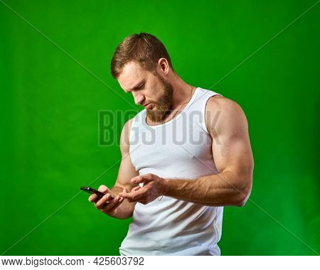 I Didnt Understand What Happened On The Phone. The Man Looks Seriously At The Smartphone Screen. Sur
