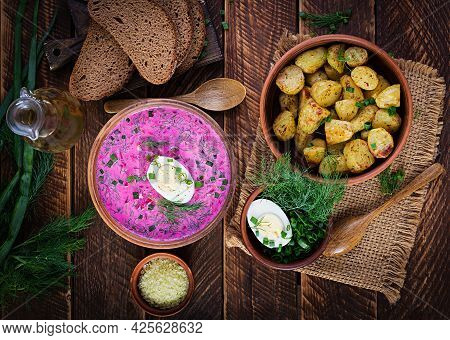 Cold Borscht, Summer Beet Soup With Fresh Cucumber,  Boiled Egg And Baked Potatoes On Wooden Table. 