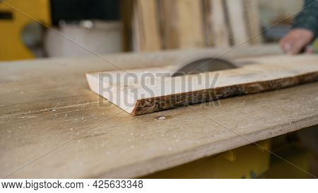 Cutting Wooden Board On A Table Saw. Woodworking And Carpentry. Furniture Manufacturing. A Craftsman