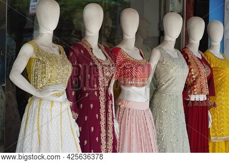 Mannequins Dressed In Latest Fashion In Front Of Retail Clothes Shop. Fashion And Retail Shopping Co