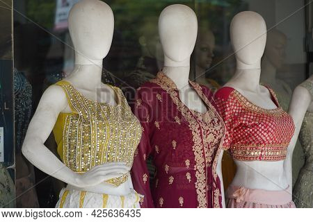 Mannequins Dressed In Latest Fashion In Front Of Retail Clothes Shop. Fashion And Retail Shopping Co