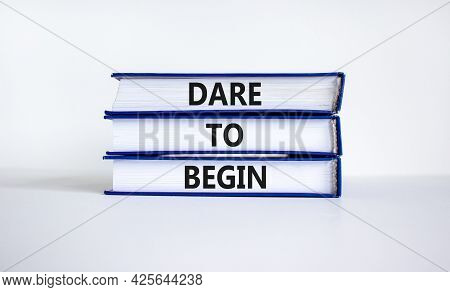 Dare To Begin Symbol. Books With Words 'dare To Begin'. Beautiful White Background. Business, Dare T