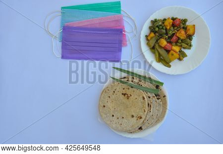 Overhead View Of Mix Veg Of Matar Paneer And Shimla Mirch Recipe With Chapati (roti) And Face Mask I