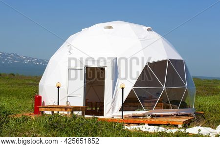 White Geodome Tent. Cozy Glamping, Holiday, Vacation Lifestyle Concept.