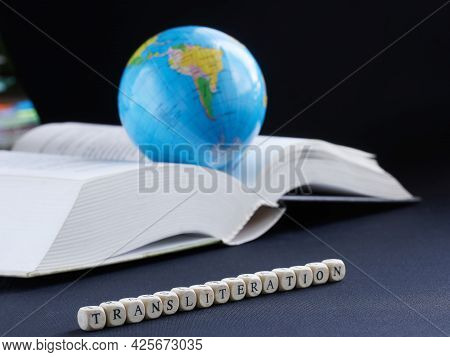 Transliteration Inscription Next To Globe And Open Book. Concept Of Educational Work On Translation 