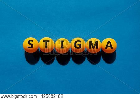 Medical And Stigma Symbol. The Concept Word 'stigma' On Orange Table Tennis Balls On A Beautiful Blu